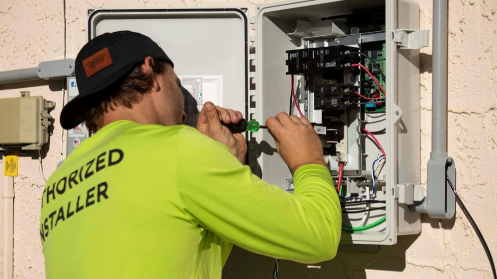 Licensed electrician installing a new breaker panel in a Grand Bend area home